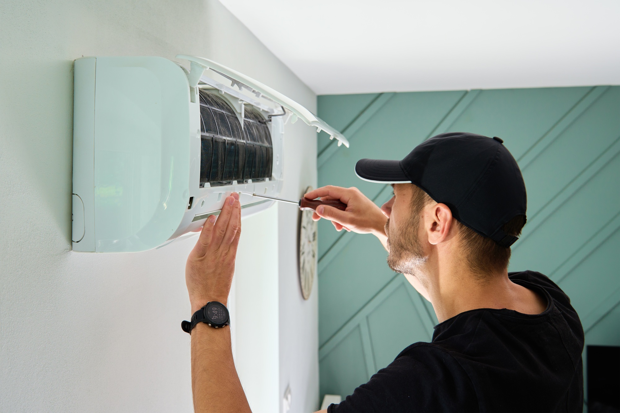 Air conditioner maintenance. Male technician repairing cooling system